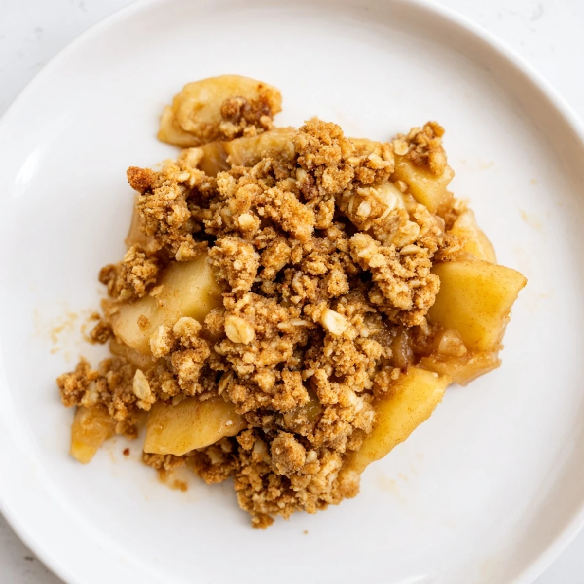 A generous serving of Warm Rustic Apple and Cinnamon Crumble, with a crisp, buttery crumble topping.