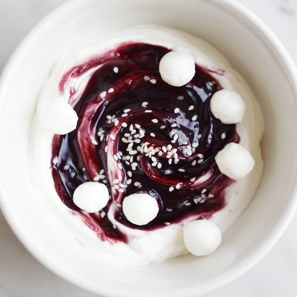 Glimpse the Galaxy Spiral dessert: vibrant berry swirls with goat cheese "stars," a beautiful, sweet dairy delight.