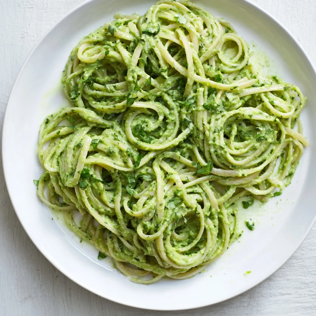 Freshly made Green Goddess Pasta Sauce boasts bright green color with a hint of Parmesan for serving.