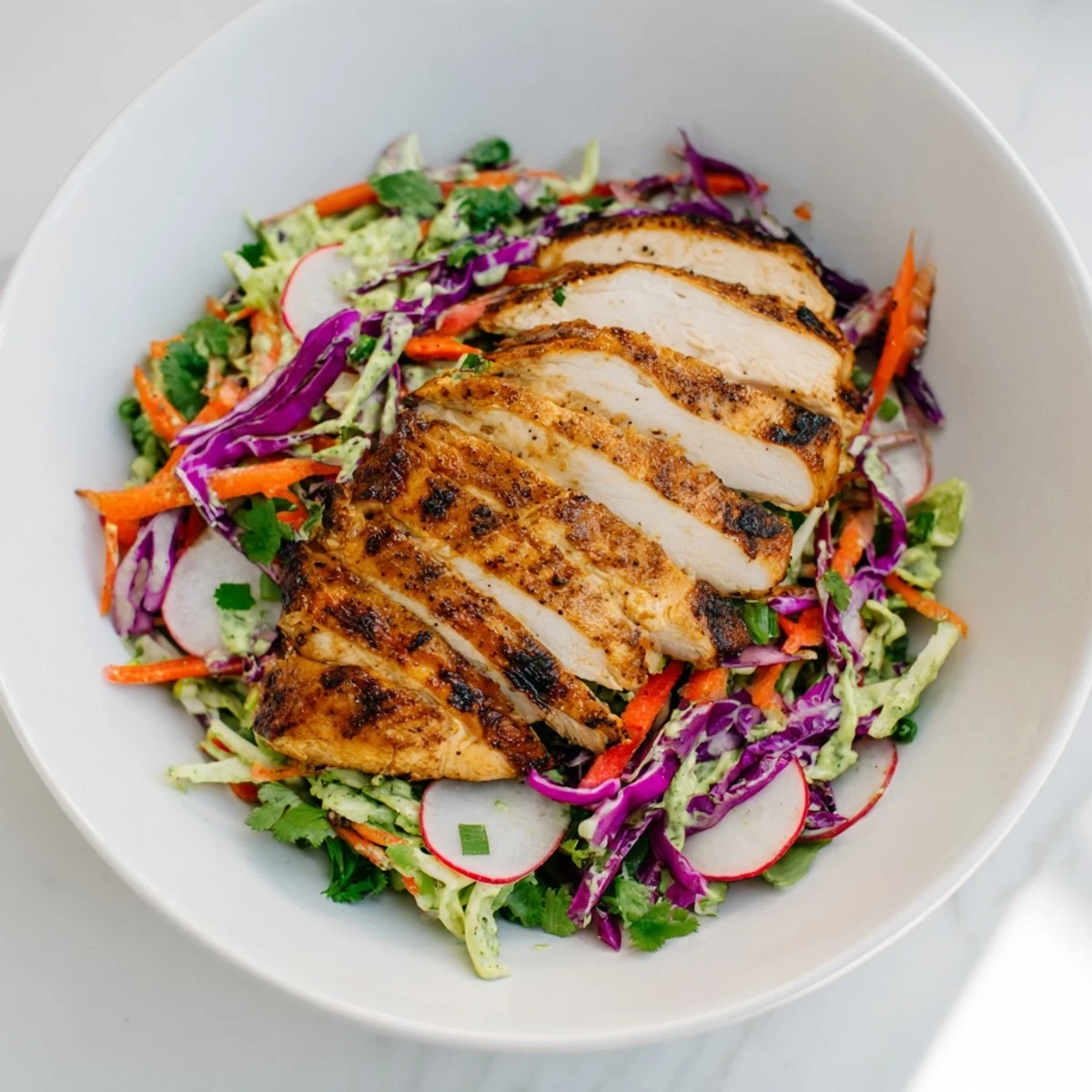 Green Goddess Cabbage Slaw with Grilled Chicken, with colorful cabbage and juicy grilled chicken.