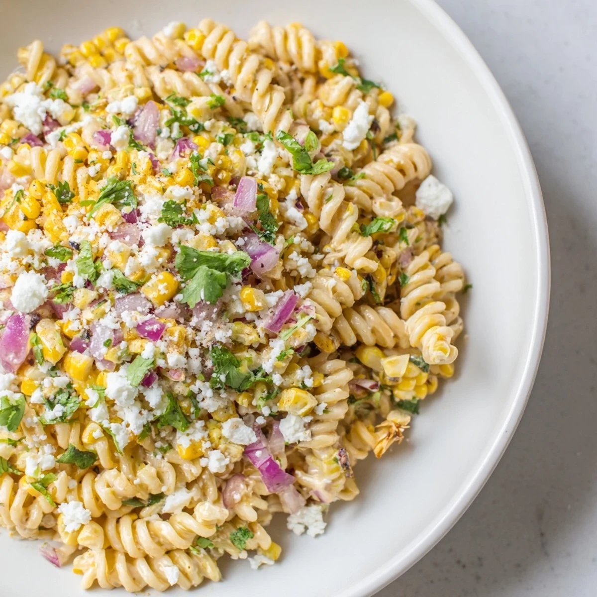 Tender pasta and cotija cheese combine in this flavorful Creamy Street Corn Pasta Salad recipe.