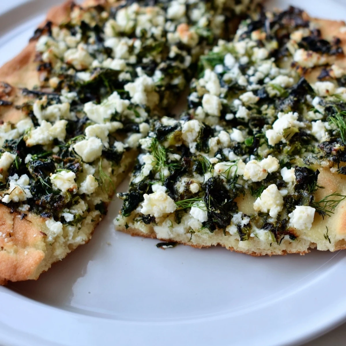 Golden, savory Turkish Spinach & Feta Flatbread, freshly baked and ready to be enjoyed as a tasty appetizer.