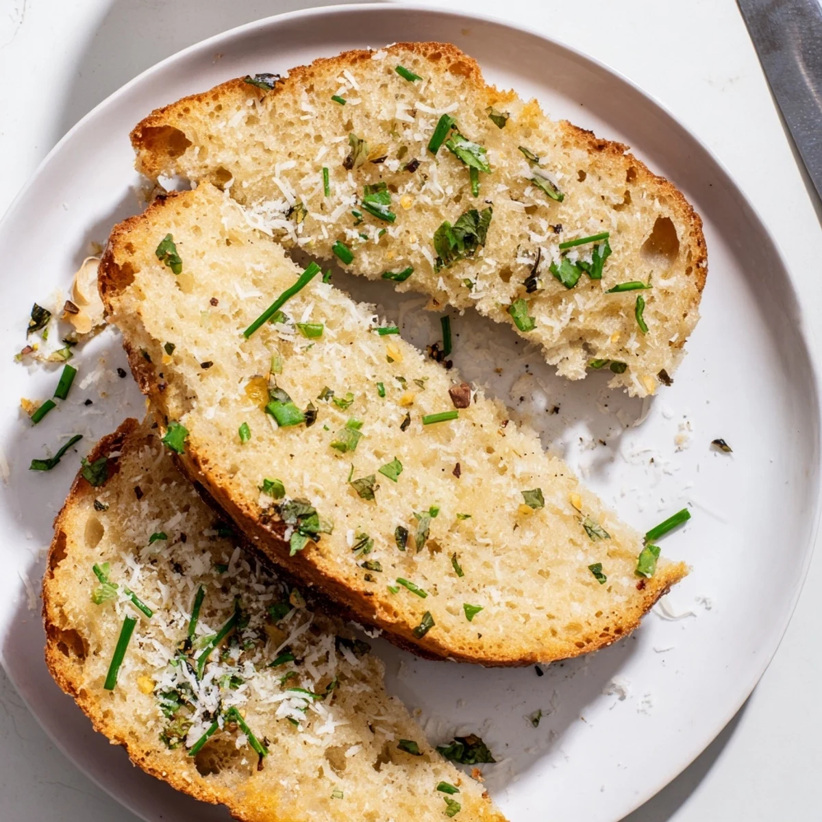 Golden brown cloud bread savory toasts topped with fresh chives and parsley, ready to be dipped in marinara sauce.  