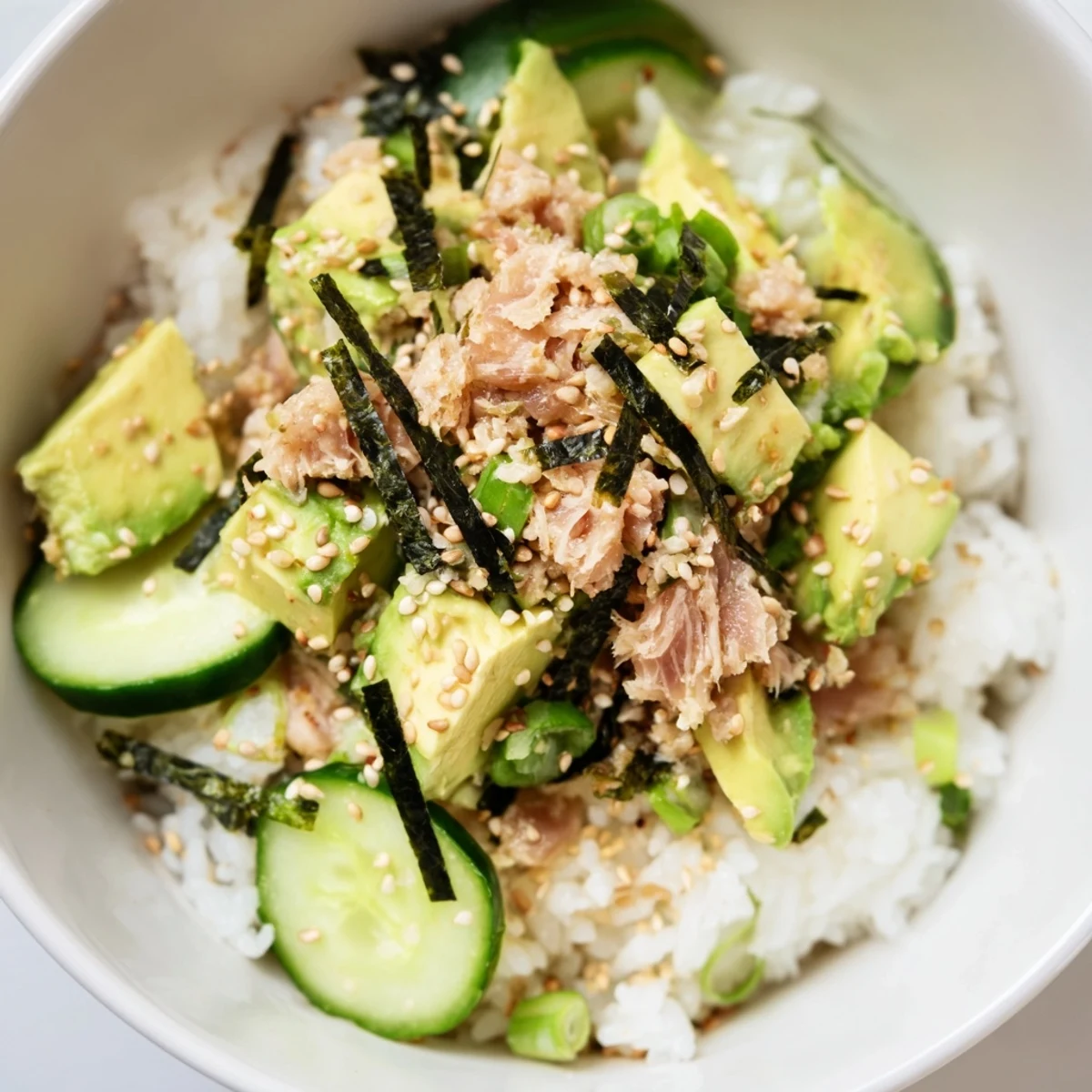 This colorful Tuna Avocado Rice Bowl features tender tuna, ripe avocado, and crunchy cucumber on fluffy jasmine rice.