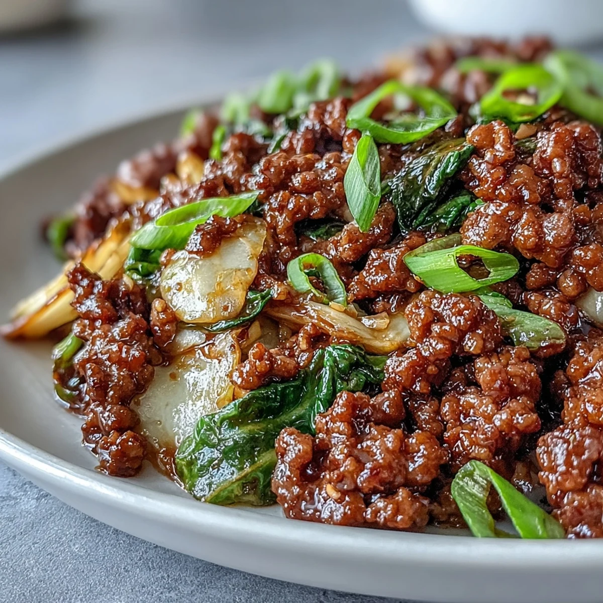 Sizzling Chinese Ground Beef and Cabbage Stir-Fry with crisp-tender green cabbage and savory beef in a glossy dark sauce. 