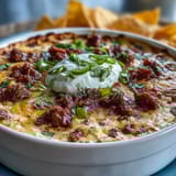 Cinco de Mayo Loaded Queso Dip with spicy chorizo and fresh pico de gallo, served warm with crispy tortilla chips.