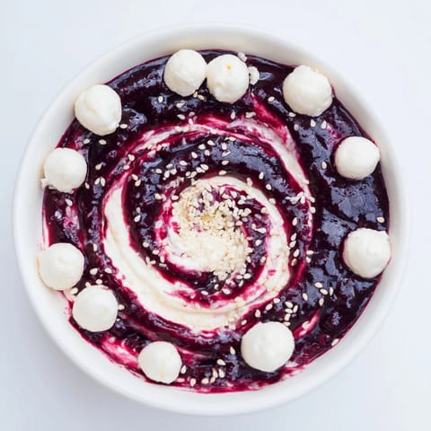 A beautiful Galaxy Spiral, featuring berries and creamy yogurt garnished with sesame seeds ready to eat.