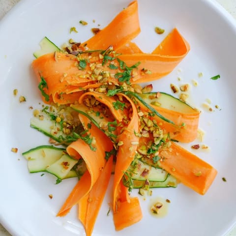 Close-up of a refreshing Citrus Carrot Ribbon Salad, with colorful carrot ribbons and zesty dressing.