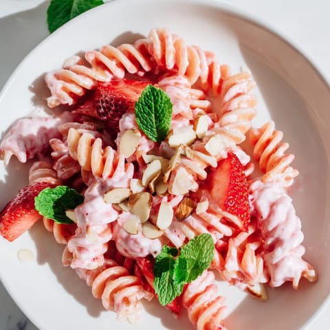 This Sweet Strawberry Yogurt Pasta showcases a cool, refreshing mix of pasta, strawberries, and a yogurt swirl.
