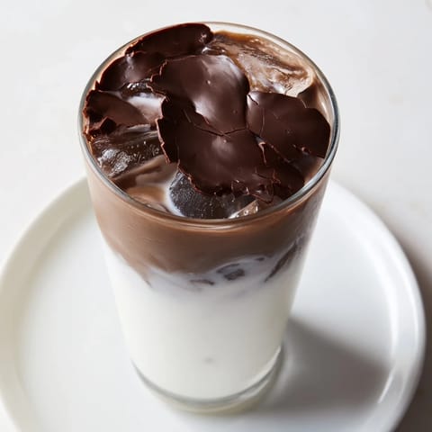 The delicious chocolate cracking iced latte, with a crisp chocolate topping and cold espresso ready to sip.