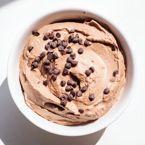 Decadent chocolate hummus, perfectly thick and rich, ready for dipping and a satisfying treat.