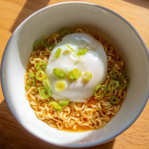 Enjoy a quick and easy upgrade of your instant ramen, beautifully garnished with fresh scallions and butter.