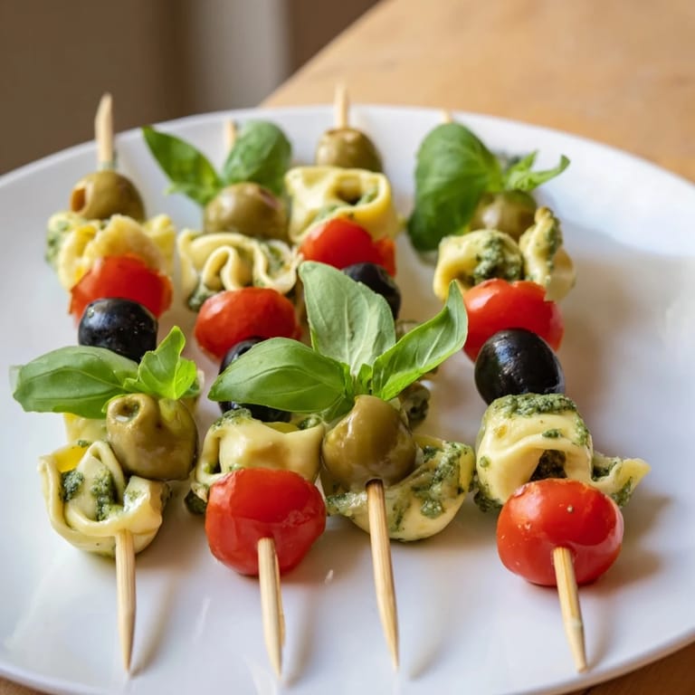 Close-up of appetizing Tortellini, Pesto, and Olive Appetizer Skewers, perfect for a party, with bright colors.