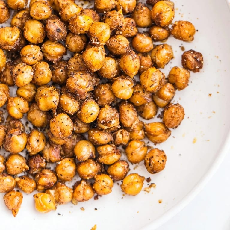 A close-up of perfectly roasted Crispy Chickpea Snack, seasoned with paprika and cumin for irresistible flavor and texture.