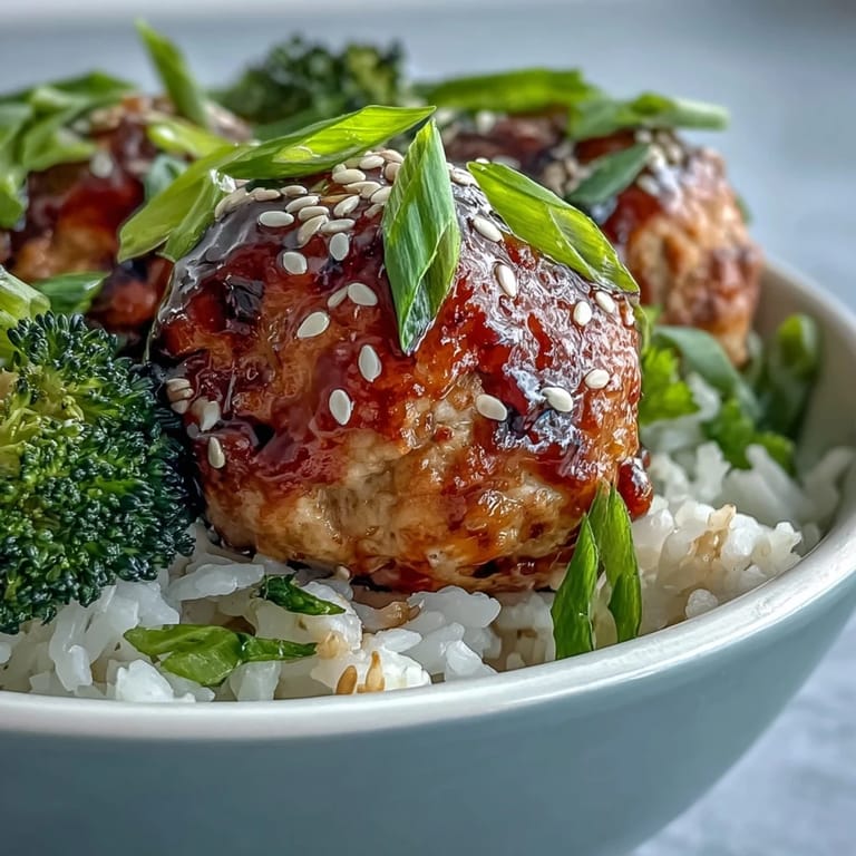 Golden baked turkey meatballs in sweet garlic glaze sit atop rice and broccoli for dinner.